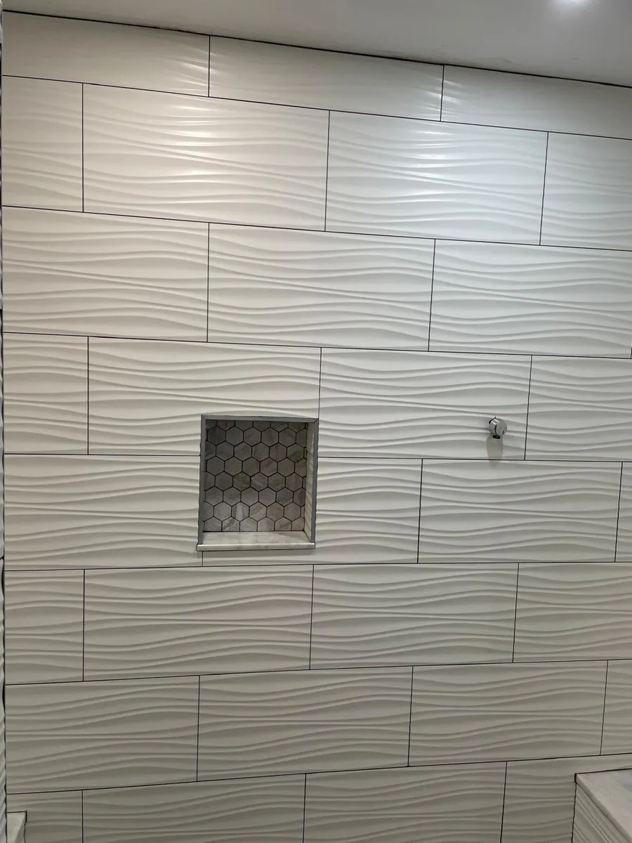 White wave-textured wall tile with a recessed shower niche